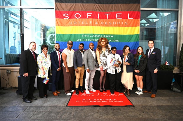 People post for photos at a Pride event at Sofitel Hotel in Philadelphia 