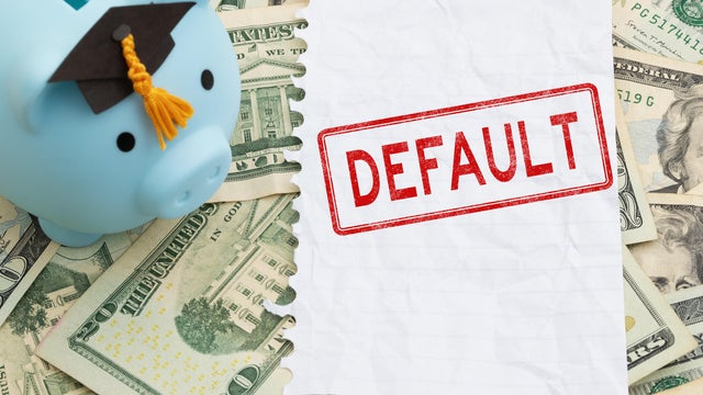 Default text with piggy bank with grad cap with torn blank paper on twenty dollar bills for student loan payments 