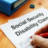 Man filling in Social Security Disability Claim. 