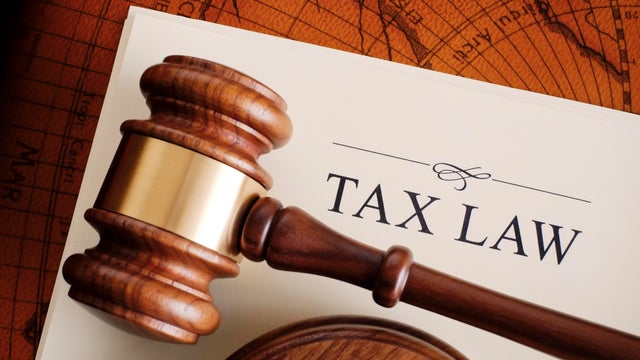Brown gavel on a white tax law document 