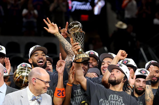 Jalen Brunson #11 of the New York Knicks lifts the Bill Russell NBA Finals Most Valuable Player Award trophy after defeating the San Antonio Spurs in Game Five of the 2026 NBA Finals at Frost Bank Center on June 13, 2026 in San Antonio, Texas.