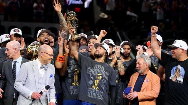 Jalen Brunson #11 of the New York Knicks lifts the Bill Russell NBA Finals Most Valuable Player Award trophy after defeating the San Antonio Spurs in Game Five of the 2026 NBA Finals at Frost Bank Center on June 13, 2026 in San Antonio, Texas. 
