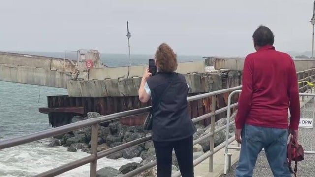 two people looking at a pier 