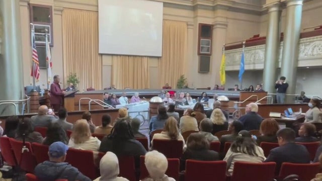 residents in a city council chamber 