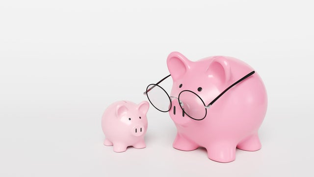 A big pink mother piggy bank wearing spectacles and a smaller one on a white background. Illustration of the concept of investment, fund and planning for children education 