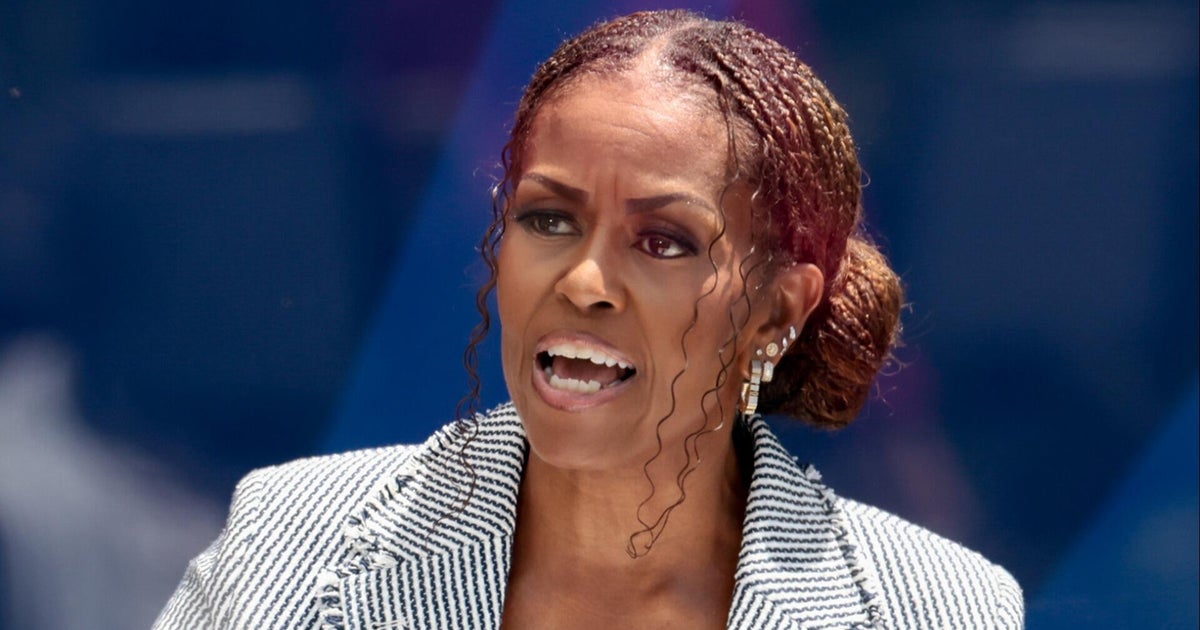 Former first lady Michelle Obama praises her husband in presidential center dedication speech