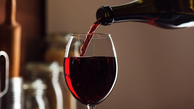 Red wine being poured in a glass 