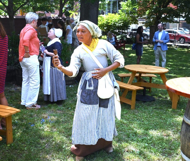 People pose for photos at City Tavern Garden 