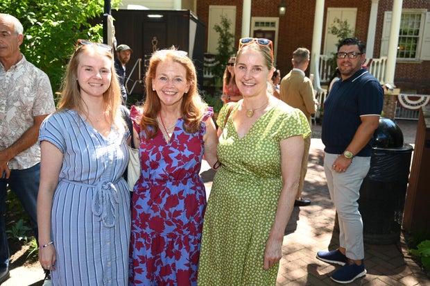 People pose for photos at City Tavern Garden 