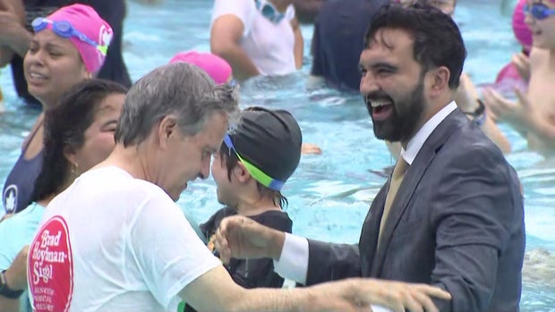 Mayor Zohran Mamdani in a pool in a full suit