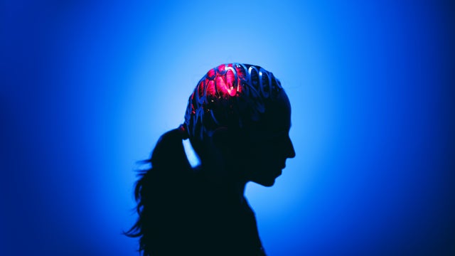 Profile headshot silhouette in vibrant abstract light, suggesting innovation and contemplation, topics of brain and cognitive functions 