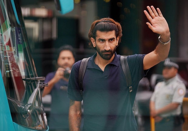Iran's Alireza Beiranvand waves to fans outside the team hotel as they depart from Tijuana, Mexico, June 30, 2026.