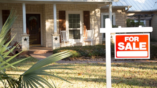 Home for sale with real estate sign.  Front Yard. 