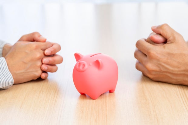 A man and a woman discussing money. 