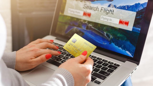 A woman shows her air ticket to a friend on a commercial aircraft 