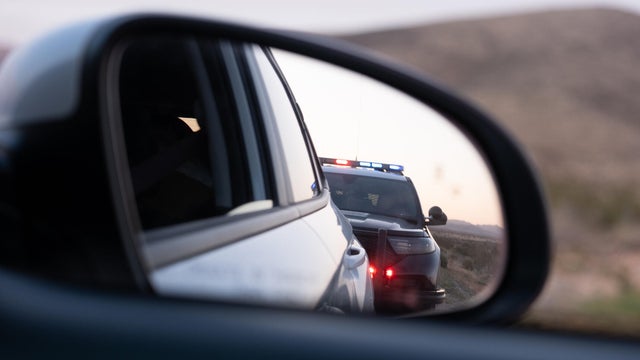 Police traffic stop in rear view mirror 
