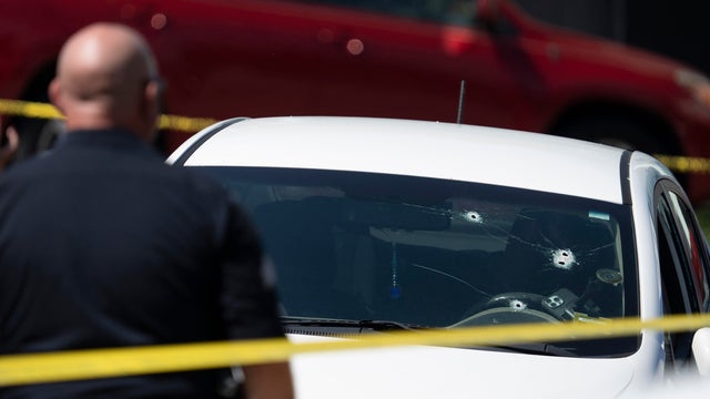 A Kia sedan with four bullet holes in the windshield is seen at the scene of a shooting in Biddeford, Maine, July 13, 2026. 