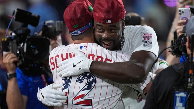 Jordan Walker and Kyle Schwarber embrace after Walker won the Home Run Derby 