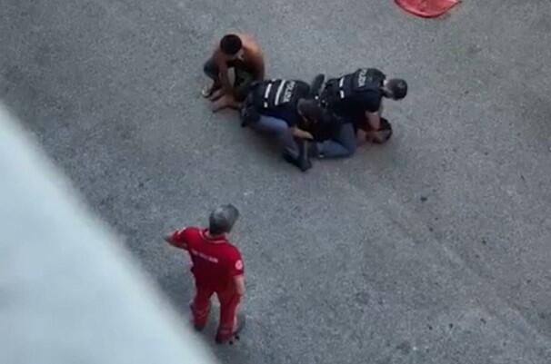 A screengrab from amateur video shared widely on social media, including by the family of Moroccan-born Italian Abderrahim Fakir, shows him being held down by two police officers and a third man on July 19, 2026, in Bologna, Italy, during an attempted arrest that ended with his death.