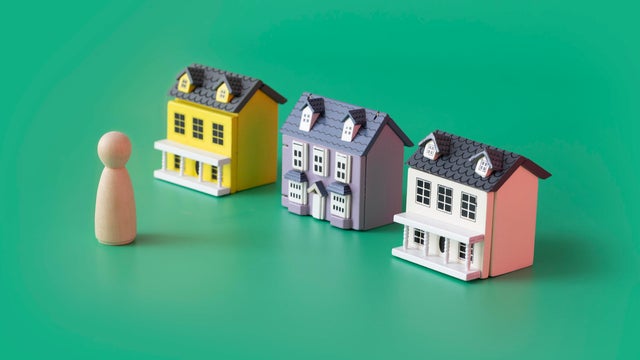 House ownership concepts still life with model house and figurine. 