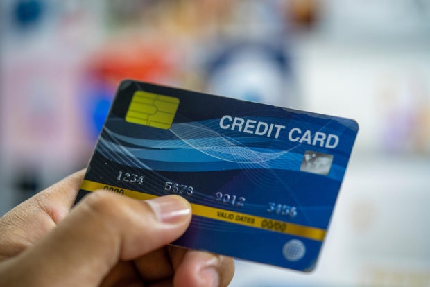 Close up a man hand holding a blue credit card.