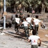 Lebanese volunteer rescue workers carry the body of an 