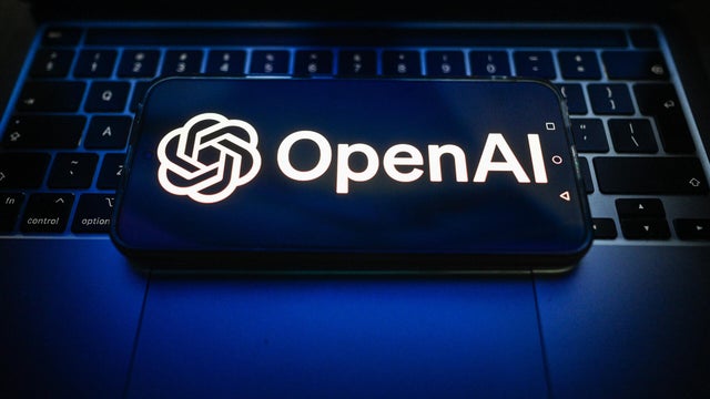 In this photo illustration, an OpenAI logo is seen displayed 