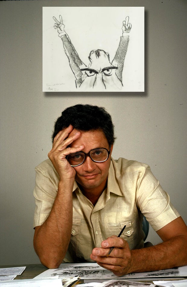 Cartoonist Patrick Oliphant at his drawing desk in his 