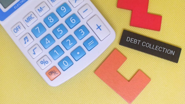 Calculator and debt collection concept on yellow background 
