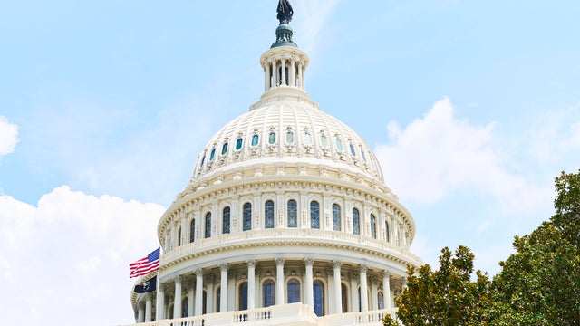 United States Capitol Building Dome with American Flag waving 