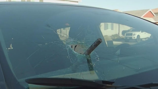 metal bolt through minivan windshield 