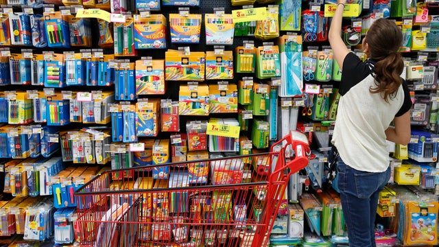 Teenager shopping for school supplies in a supermarket 