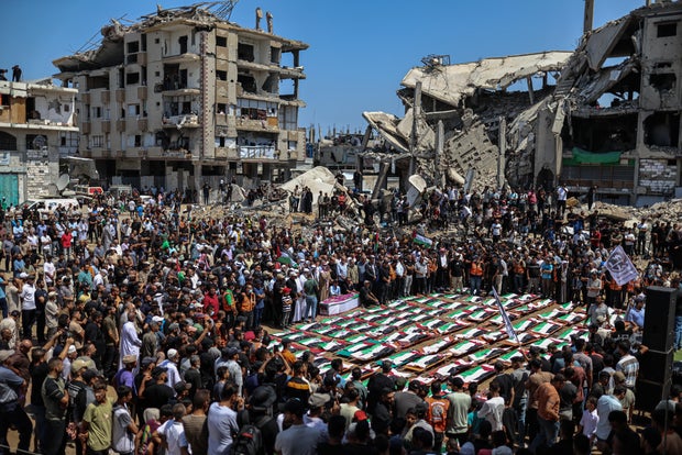 People attend a mass funeral In the Gaza Strip