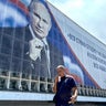 A man walks past a billboard displaying a portrait of Russia's President Vladimir Putin in Sevastopol, on the Russian-annexed peninsula of Crimea, on July 23, 2026. 
