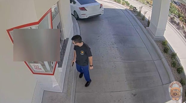 The gunman in a deadly mass shooting in Twin Falls, Idaho, looks into an In-N-Out restaurant during the rampage, Aug. 1, 2026.