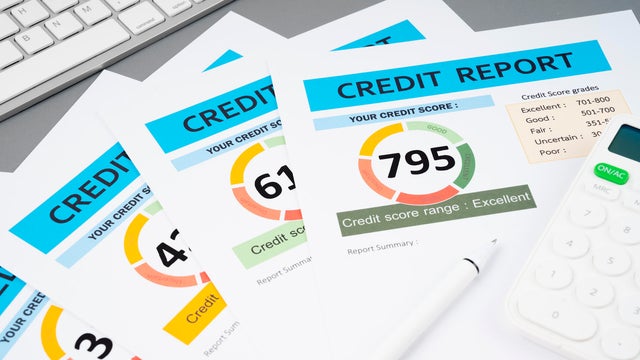 The Credit score report document and pen with calculator on the desk. 