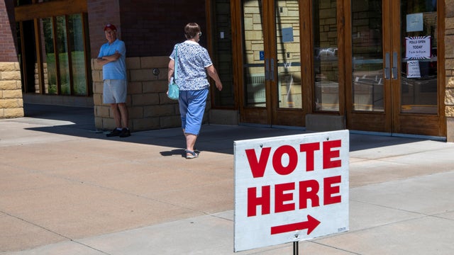 Vadnais Heights, Minnesota. Woman entering polling station on primary election day. 