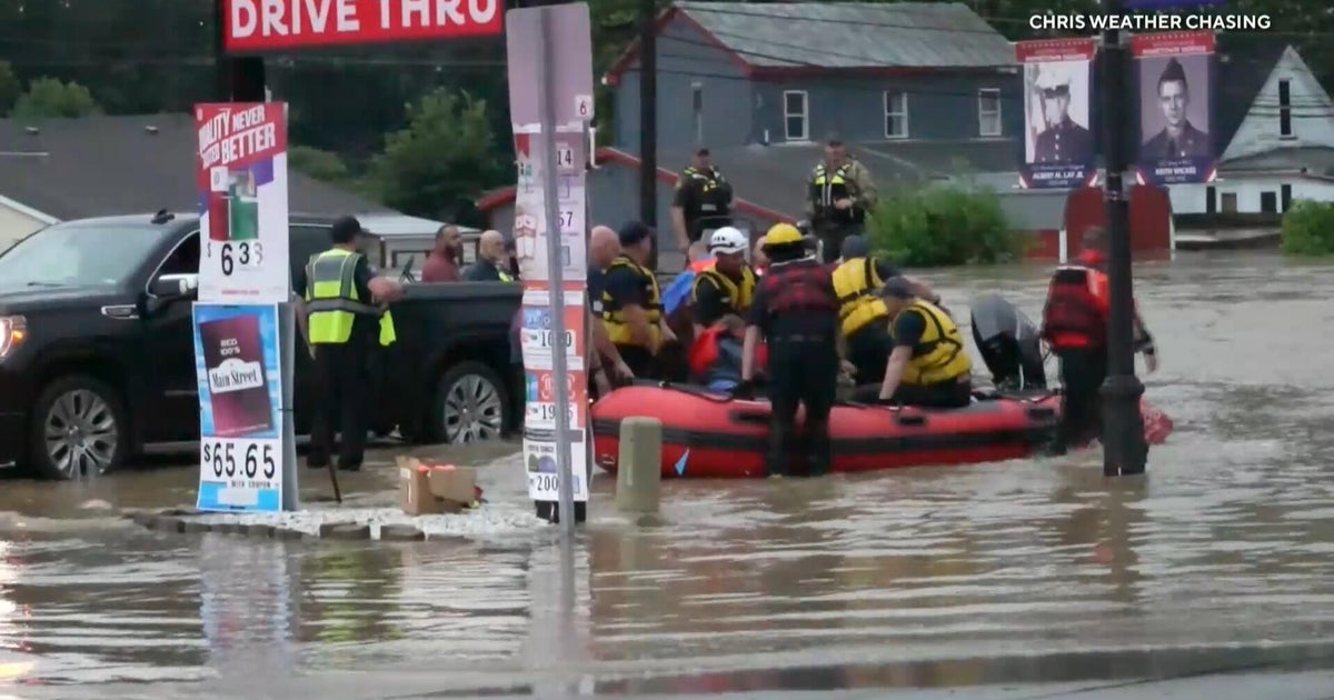First responders use boats to rescue people from flooded homes, cars in Midwest