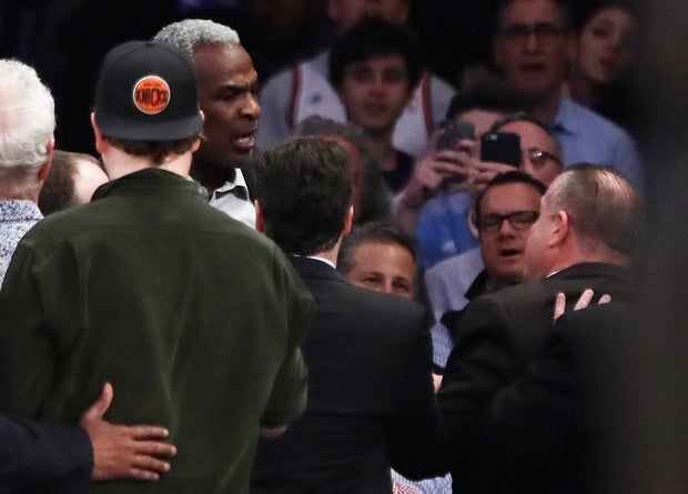 Former New York Knicks player Charles Oakley, rear left, exchanges words with a security guard during the first half of an NBA basketball game between the Knicks and the Los Angeles Clippers in New York on Feb. 8, 2017. 