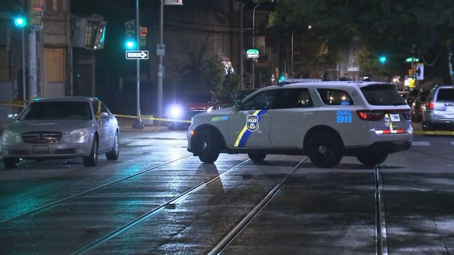 Police vehicle and police tape are at the scene of a shooting on the 4100 block of Germantown Avenue 