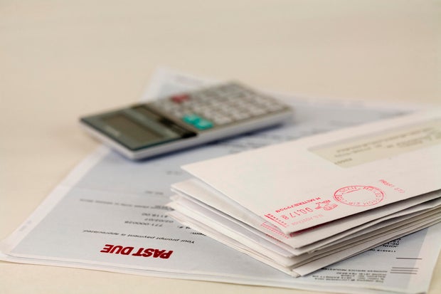 A stack of bills and a calculator 