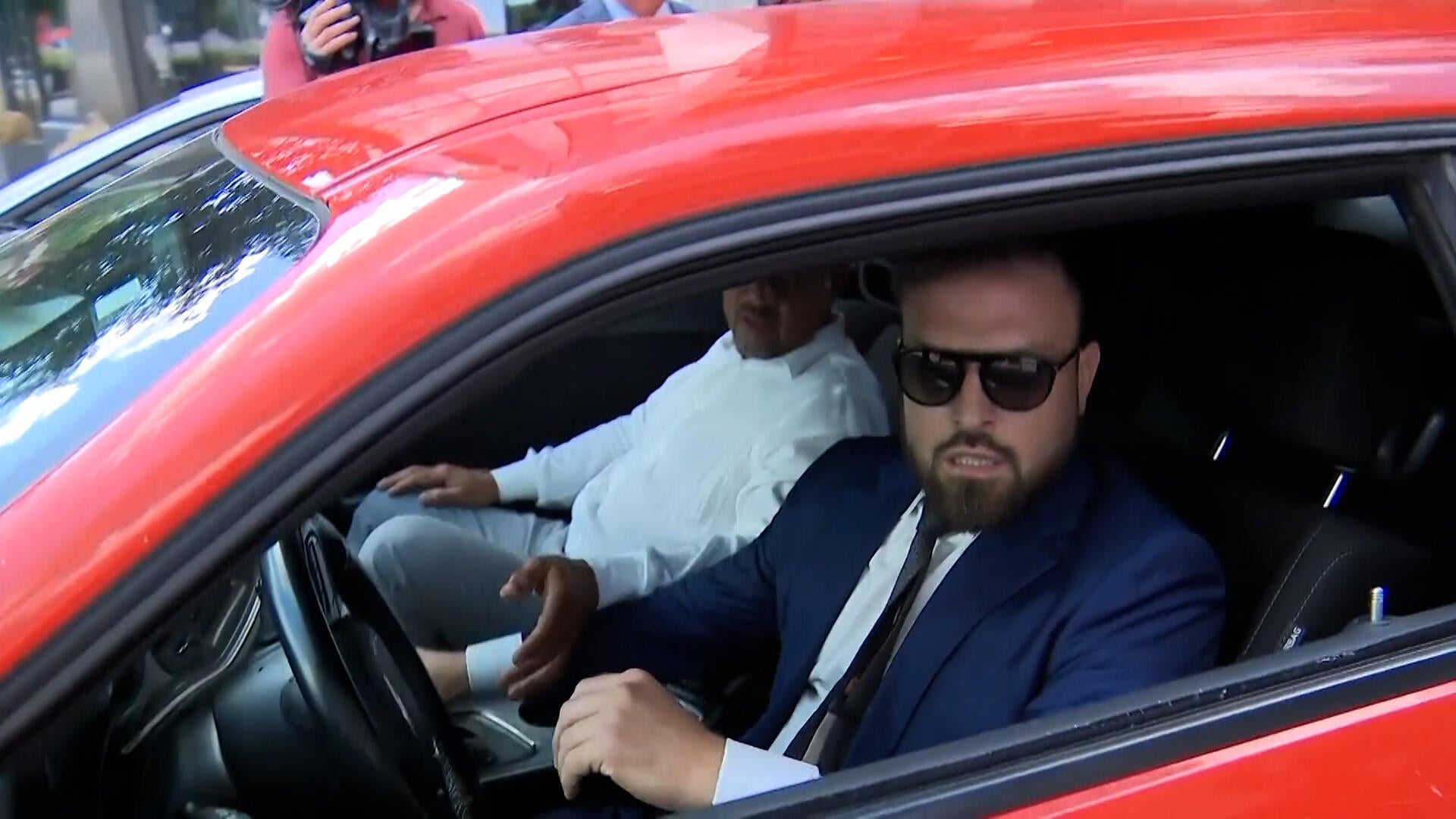 Watch: Lawyer hits car while trying to escape reporters outside courthouse