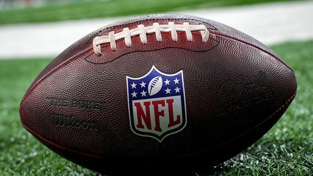 The NFL logo is seen on a football before a preseason game between the Washington Commanders and Detroit Lions at Ford Field on Aug. 22, 2026, in Detroit, Michigan. 