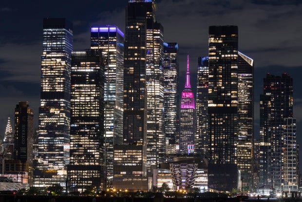 The Empire State Building in New York City celebrates the life of Dolly Parton by illuminating in pink at 9.25pm, a nod to her movie "9 To 5", following her death on August 24, 2026, as seen from Weehawken, New Jersey. 