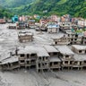 An aerial view shows houses deluged in sludge after flash flooding at Devighat in Nepal's Nuwakot district Aug. 27, 2026. 