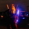 A U.S. sailor signals an F/A-18 Super Hornet on the flight deck of the USS George Washington, Aug. 29, 2026, while the aircraft carrier is deployed in the Middle East. 