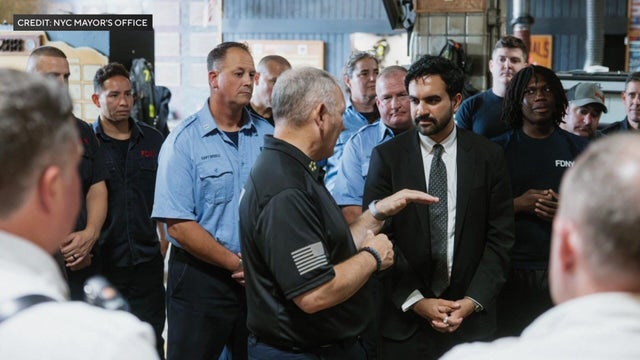 Mayor Mamdani listens to firefighters speak in a firehouse 