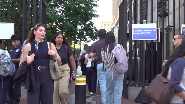 Students entering and exiting the Columbia University campus gates 