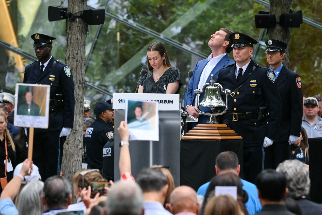 A family member looks skyward during a moment of silence at the National September 11 Memorial in New York on Sept. 11, 2026.