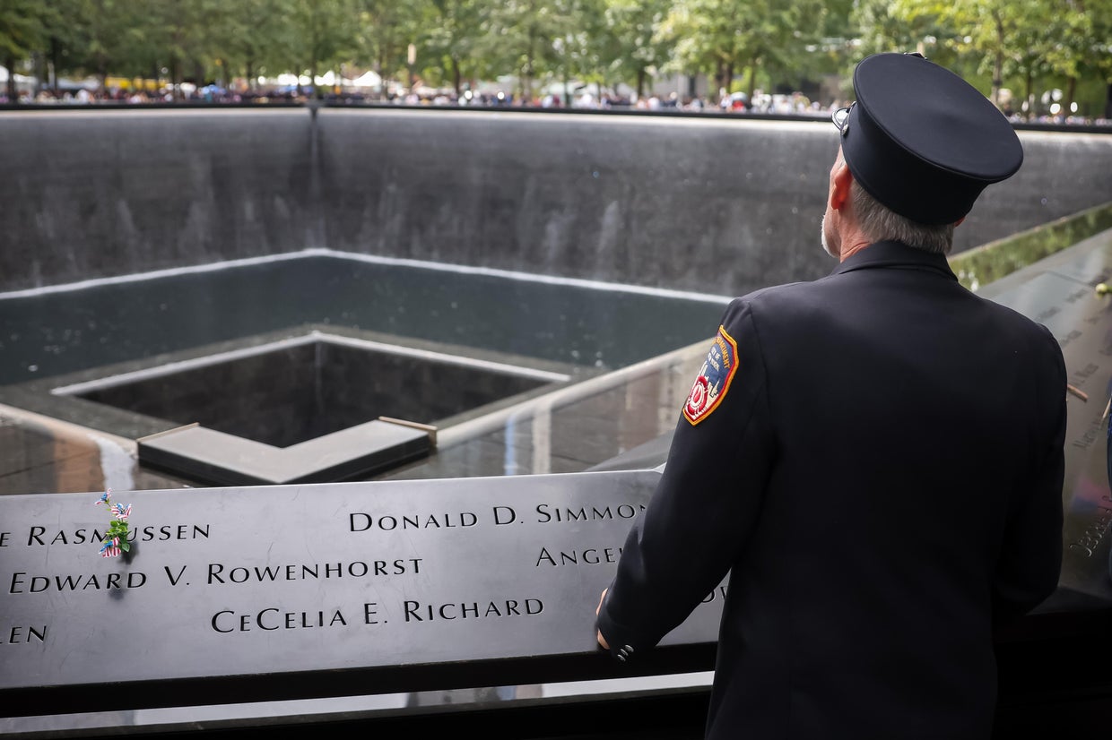 A uniformed firefighter visits the South Tower reflecting pool at the National 9/11 Memorial and Museum in New York City, Sept. 11, 2026.